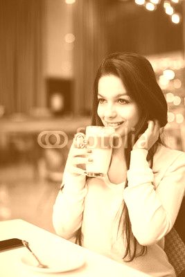 Young woman at cafe drinking coffee 