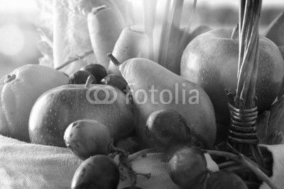 Fruits and vegetables in wicker basket front view close up