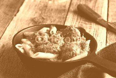 Meatball penne pasta with spicy tomato sauce and dill