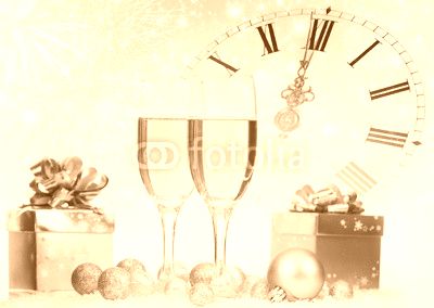 Champagne and gift box against fireworks and holiday lights