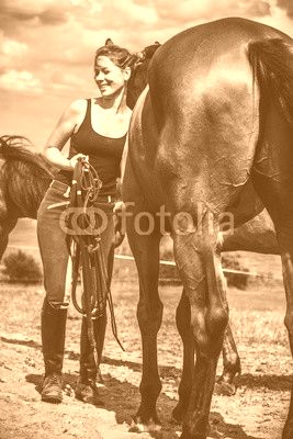 Jockey woman taking care of horse