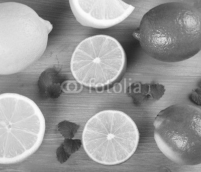 limes and lemons on a wooden background