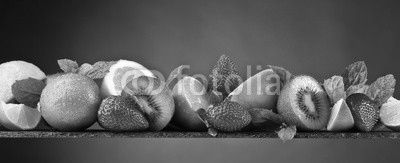 Ripe juicy fruits and peppermint with water drops