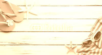 Towel and beach slippers on wood..