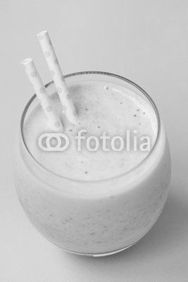 Strawberry pink smoothie in a glass with a straw on a pink background. Summer and healthy lifestyle concept.