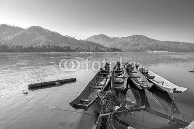 Traditional old wooden fishing boat floating on Mekong river in North Thailand, outdoor day light