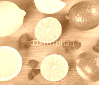 limes and lemons on a wooden background