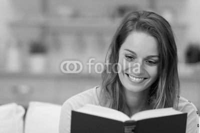 glückliche frau liest ein buch zu hause