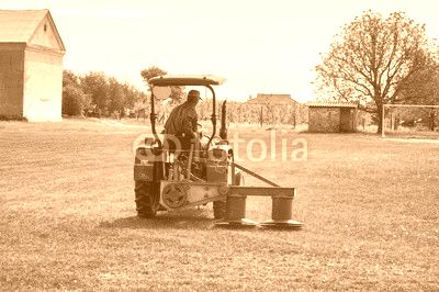 Tractor mowing the grass on the football field