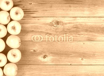 Freshly harvested golden apples on rustic wooden boards