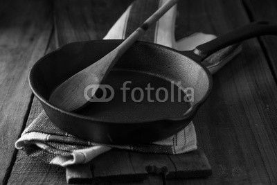 Cast iron frying pan on country rustic wooden/timber background