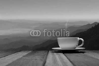Morning cup of coffee or tea with mountain background at sunrise