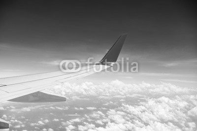 airplane wing above the clouds