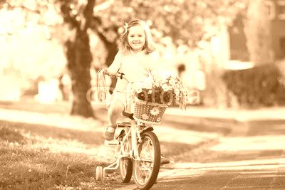 Little girl riding a bike. Child on bicycle.