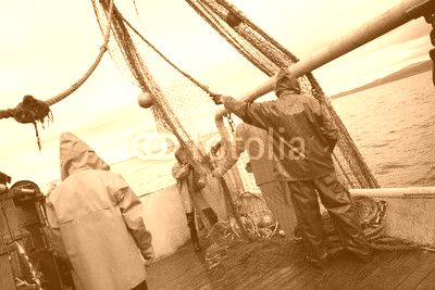 Fishermen in protective suits on deck Fishing vessel