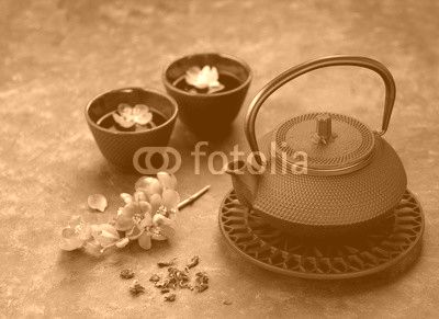 Black iron asian style teapot and cups green tea and flowers