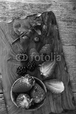 strawberry and berries on wooden cutting board