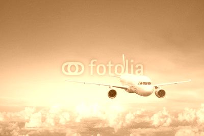 travel by plane, international flight, airplane flying in blue sky above the clouds