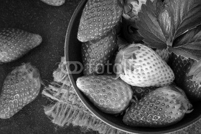  Top view of Red Strawberries and leaf with black stone background
