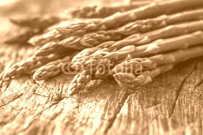 Fresh organic asparagus on rustic background