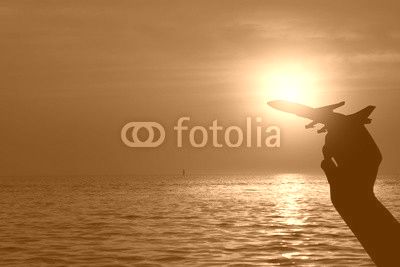 Silhouette of hand holding airplane , Travel concept