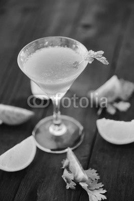 coctail with orange and tomato on black wooden table at blurred background