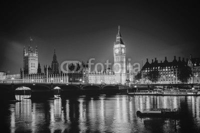 Iconic view Westminster with Big Ben, Houses of Parliament and Thames at Victoria Embankment lit up at night.