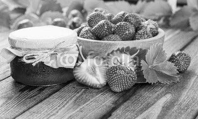 Strawberry on wood background. Strawberry with green leaves.