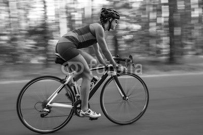 Athletic girl rides a bike