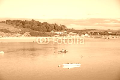 View of the Camel estuary at low tide with the touristic village Rock in Cornwall. View from Padstow on the opposite site of the estuary.