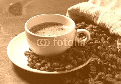 coffee cup and grains on wooden table