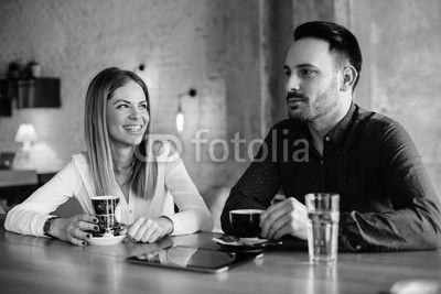 Young businesswoman and man on coffee break in cafe