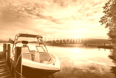 Sun and mist on boat dock at sunrise on a summer day. Merrymeeting Lake, New Hampshire