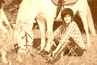 Portrait of a pretty young woman with white horse riding