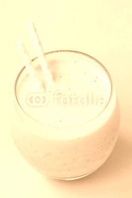 Strawberry pink smoothie in a glass with a straw on a pink background. Summer and healthy lifestyle concept.