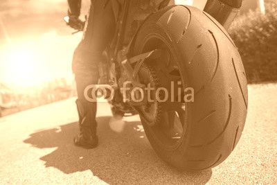 Ready to ride...man on a bike starting a tour with his motorbike on a summer evening