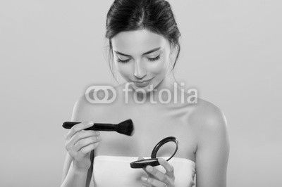 Woman applying make up